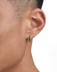Model wearing 18k gold earrings by Iceman Society