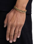 Model wearing 12mm 18k gold plain cuban bracelet by Iceman Society
