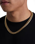 Model wearing 12mm 18k gold plain cuban necklace by Iceman Society, side view