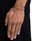Model wearing 5mm 18k gold plain cuban bracelet by Iceman Society