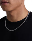 Model wearing 5mm white gold plain cuban necklace by Iceman Society, side view