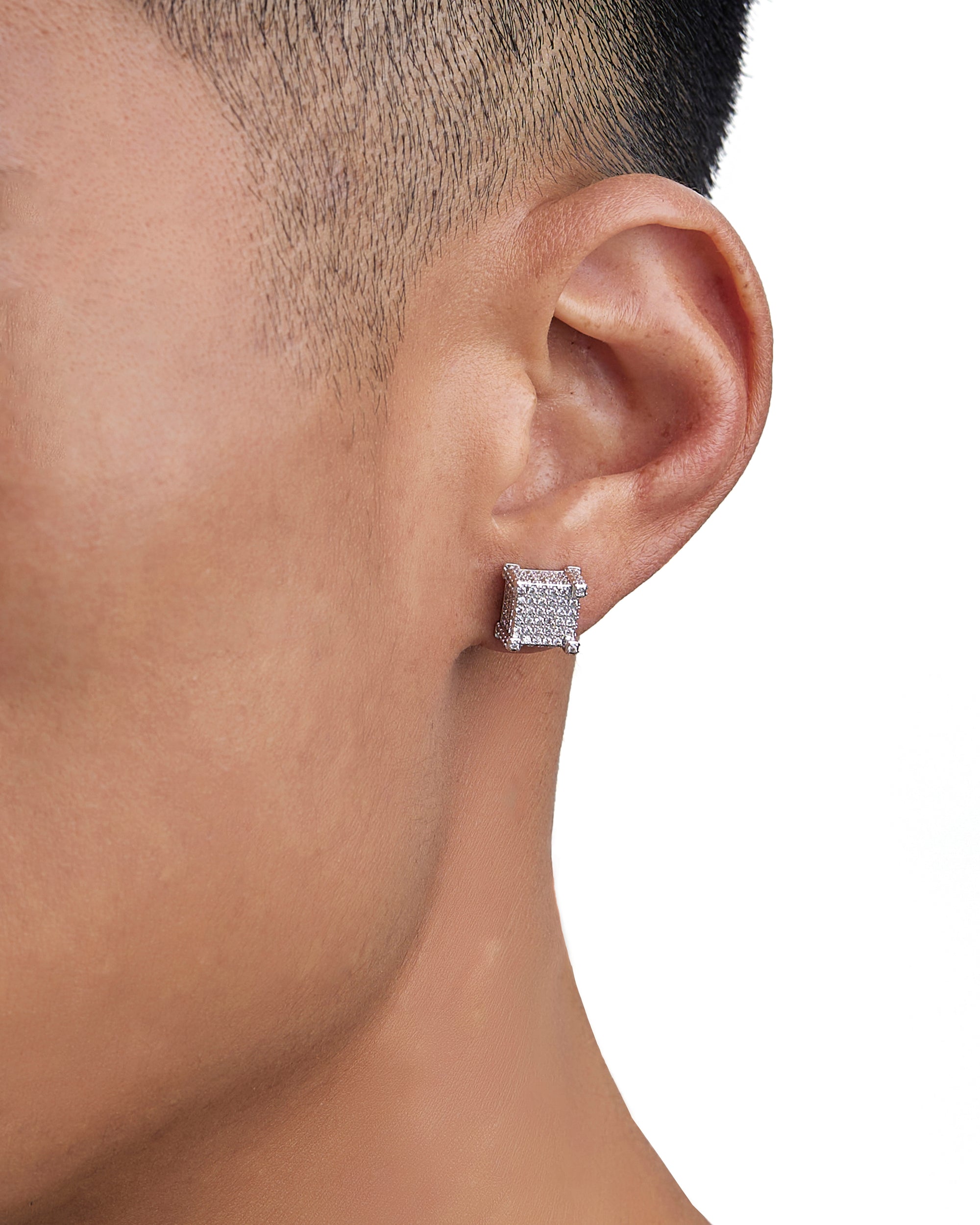 Model wearing white gold diamond earrings by Iceman Society