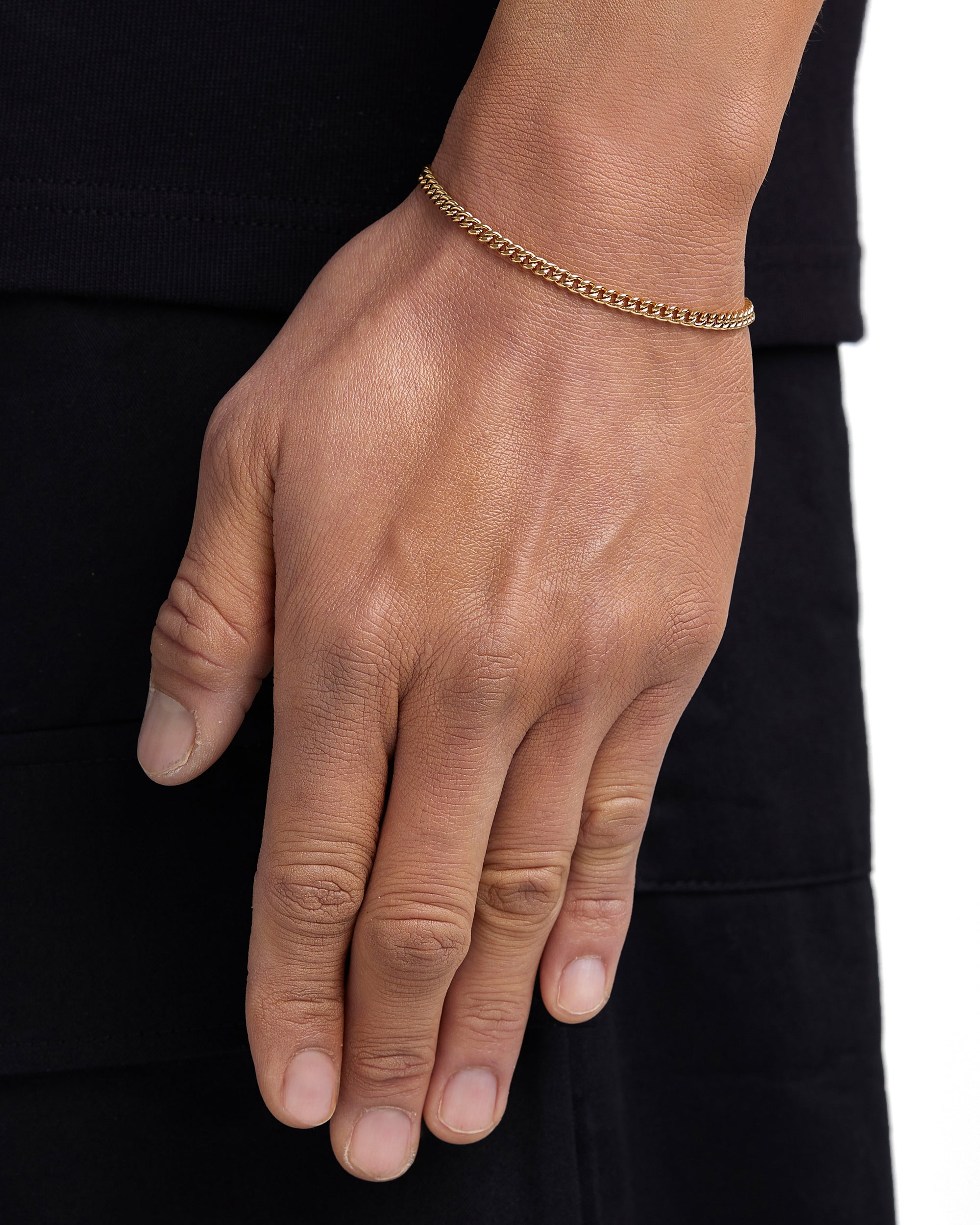 Model wearing 3mm 18k gold plain cuban bracelet by Iceman Society